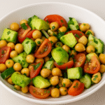 Healthy Chickpea Avocado Salad with fresh vegetables and lemon dressing – a protein-rich and low-carb Mediterranean dish.