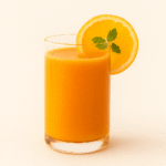 Natural citrus carrot juice in a glass with orange and lemon slices – healthy morning detox drink