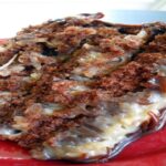 German Chocolate Coconut Layer Cake slice showing moist chocolate layers with creamy coconut-pecan frosting