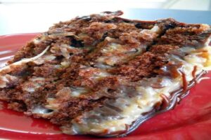 German Chocolate Coconut Layer Cake slice showing moist chocolate layers with creamy coconut-pecan frosting