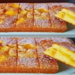 Golden and moist 5-Minute Cake dusted with powdered sugar and sliced to show its fluffy texture.