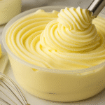 whipped pudding frosting piped in a swirl over creamy vanilla base