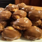 Chocolate Peanut Butter Balls coated in rich chocolate on a dessert plate