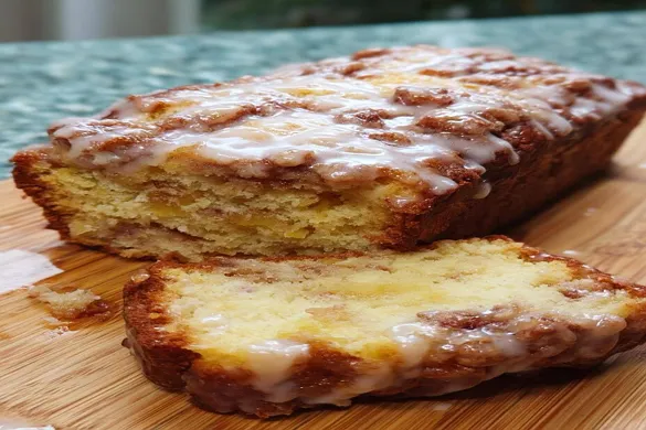 Cinnamon Swirl Apple Fritter Bread with glaze and cinnamon topping