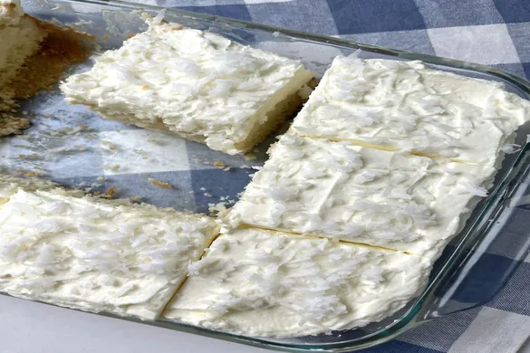 Coconut Cloud Cake recipe with fluffy whipped topping and shredded coconut