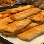 Crispy Crab Rangoon Egg Rolls with cream cheese filling, served on a plate