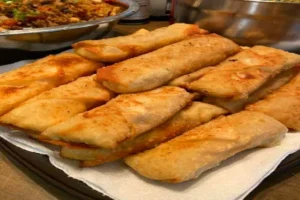 Crispy Crab Rangoon Egg Rolls with cream cheese filling, served on a plate