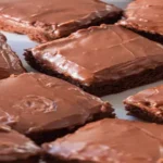 Lunch Lady Brownies cut into squares with chocolate frosting