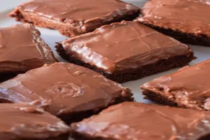 Lunch Lady Brownies cut into squares with chocolate frosting
