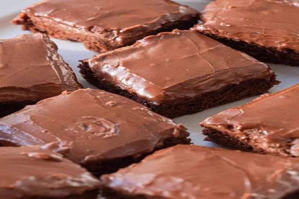 Lunch Lady Brownies cut into squares with chocolate frosting