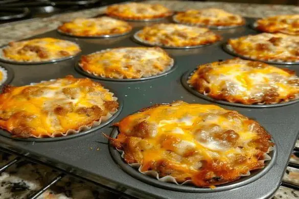 Sausage Muffins with Bisquick baked in a muffin pan with melted cheese