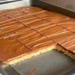 Scotcheroos bars with chocolate and butterscotch topping in a pan