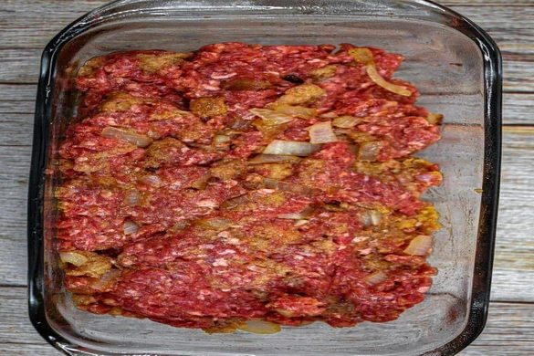 Skinny Meatloaf in a glass loaf pan ready for baking