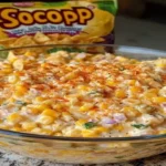 Southwest Corn Dip in a bowl topped with paprika served with tortilla chips