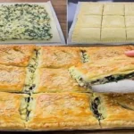 flaky spinach and cheese pie fresh from the oven with golden puff pastry