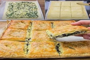 flaky spinach and cheese pie fresh from the oven with golden puff pastry