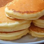 best fluffy pancakes recipe stacked golden on white plate