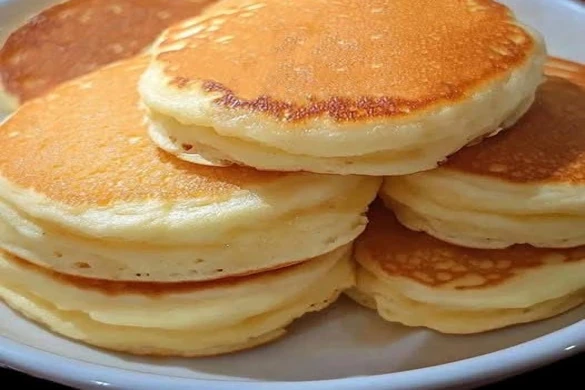 best fluffy pancakes recipe stacked golden on white plate