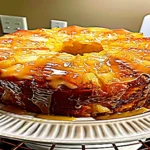 pineapple pound cake with dripping pineapple glaze on a cake stand