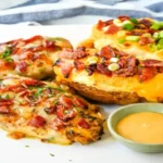 Cheesy Bacon Smothered Chicken topped with honey mustard and crispy bacon