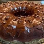 Nestlé Toll House Death by Chocolate Cake drizzled with rich chocolate ganache on a glass plate.