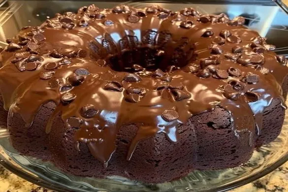 Nestlé Toll House Death by Chocolate Cake drizzled with rich chocolate ganache on a glass plate.