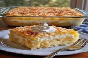 Pineapple Coconut Cake topped with toasted coconut and pineapple slices.
