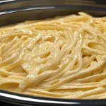 Slow Cooker Creamy Alfredo Pasta served in a bowl with parsley garnish